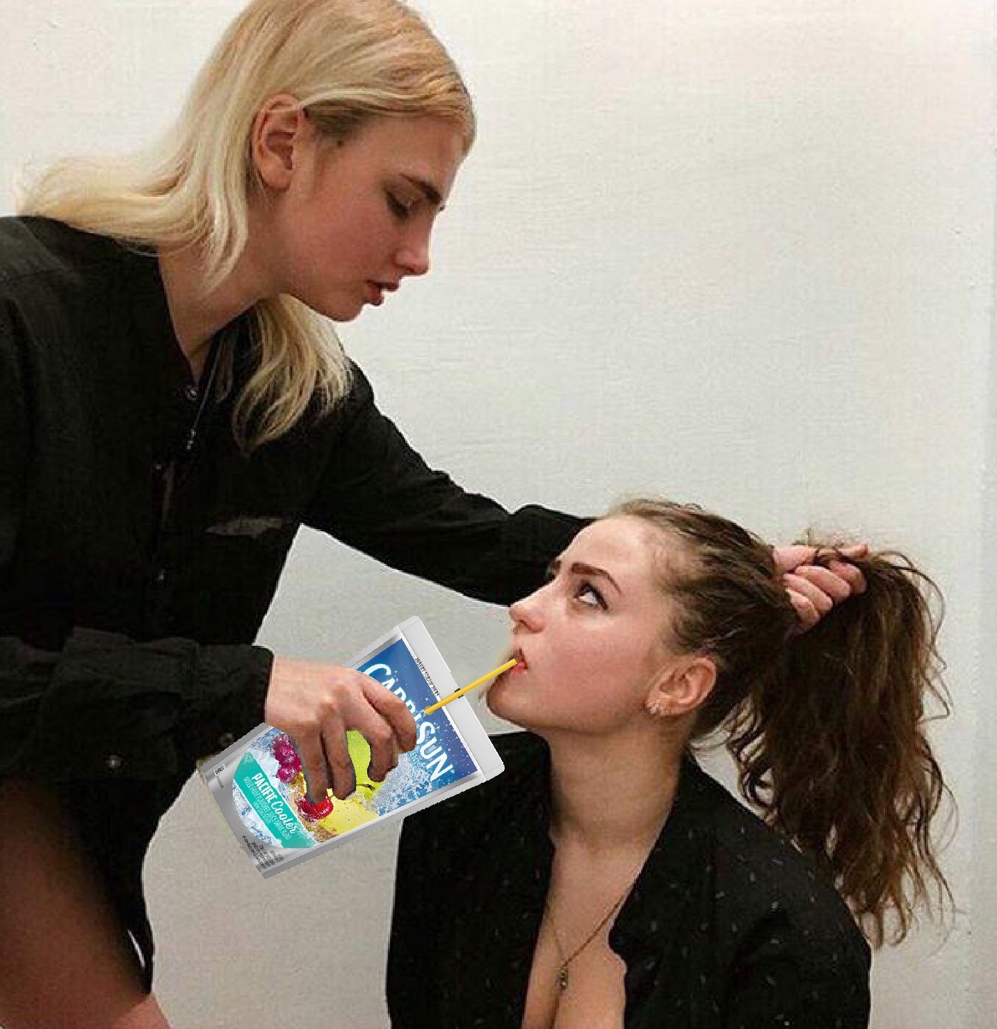 Девушка поит молоком другую