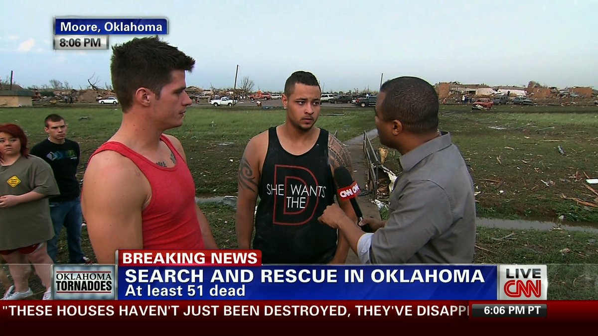A man in Oklahoma where tornadoes have killed 51 people and he has lost his house. He is wearing a tank top that says SHE WANTS THE D