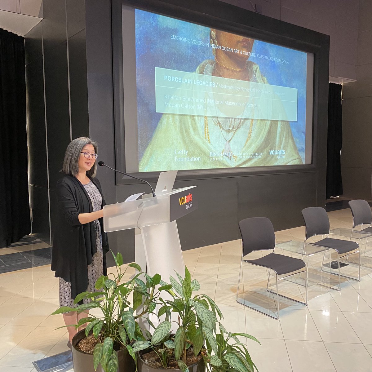 Nancy Um at the podium introducing speakers