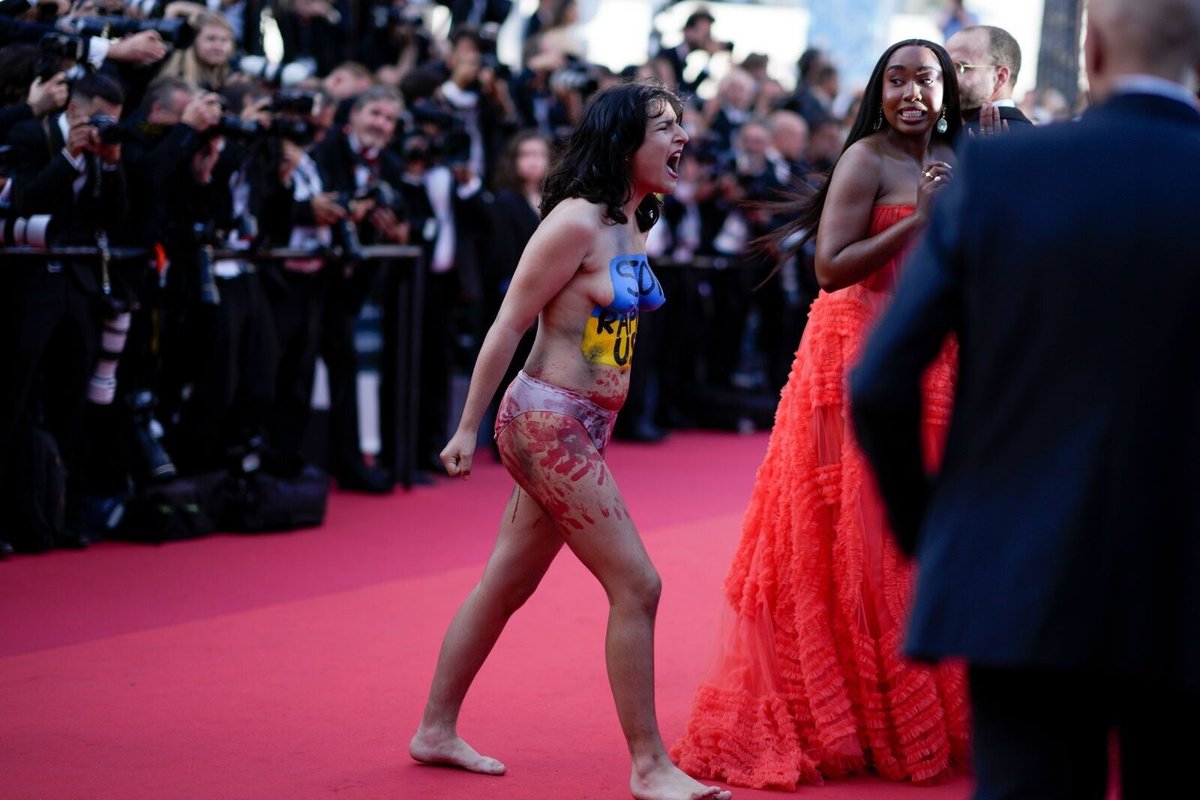 A naked girl covered in fake blood with the message saying 'Stop raping us' written on her body next to the blue and yelow colors of the Ukrainian flag, ran onto the red carpet in Cannes.

She protested against violence towards women in Ukraine during hostilities.