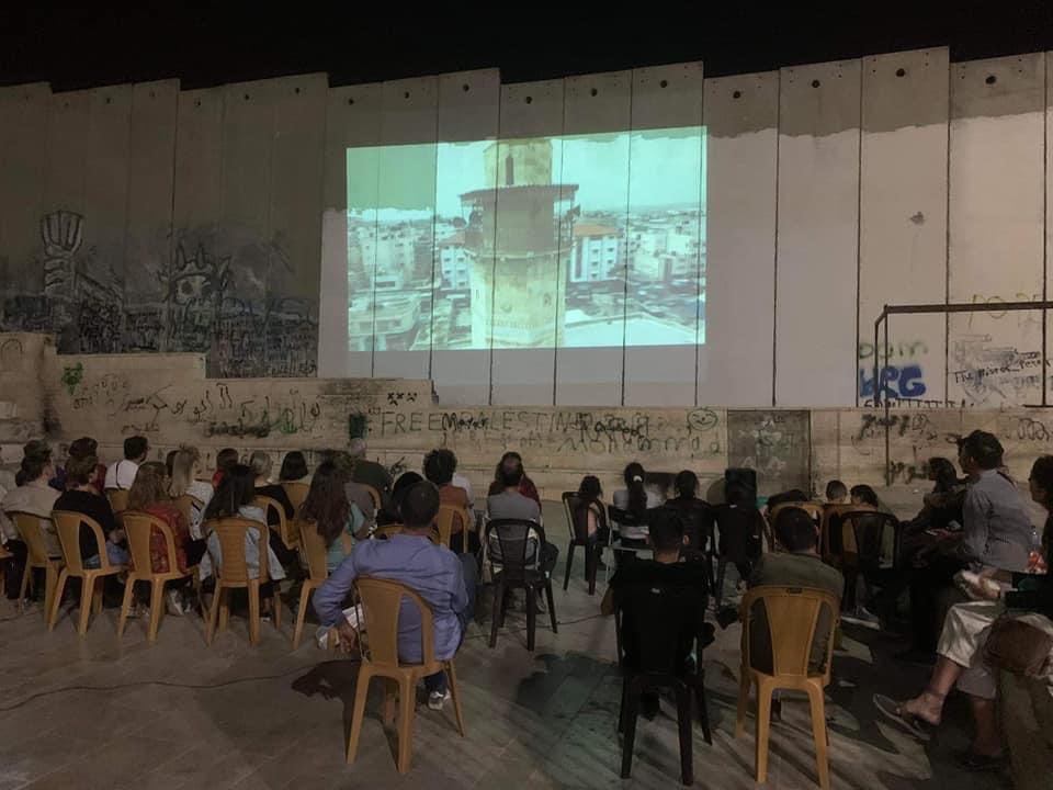yumna_patel's tweet photo. Palestinians watch a film on the Apartheid Wall in the Aida Refugee camp. 📍 Bethlehem, occupied West Bank. https://t.co/mrwWLaUwCk