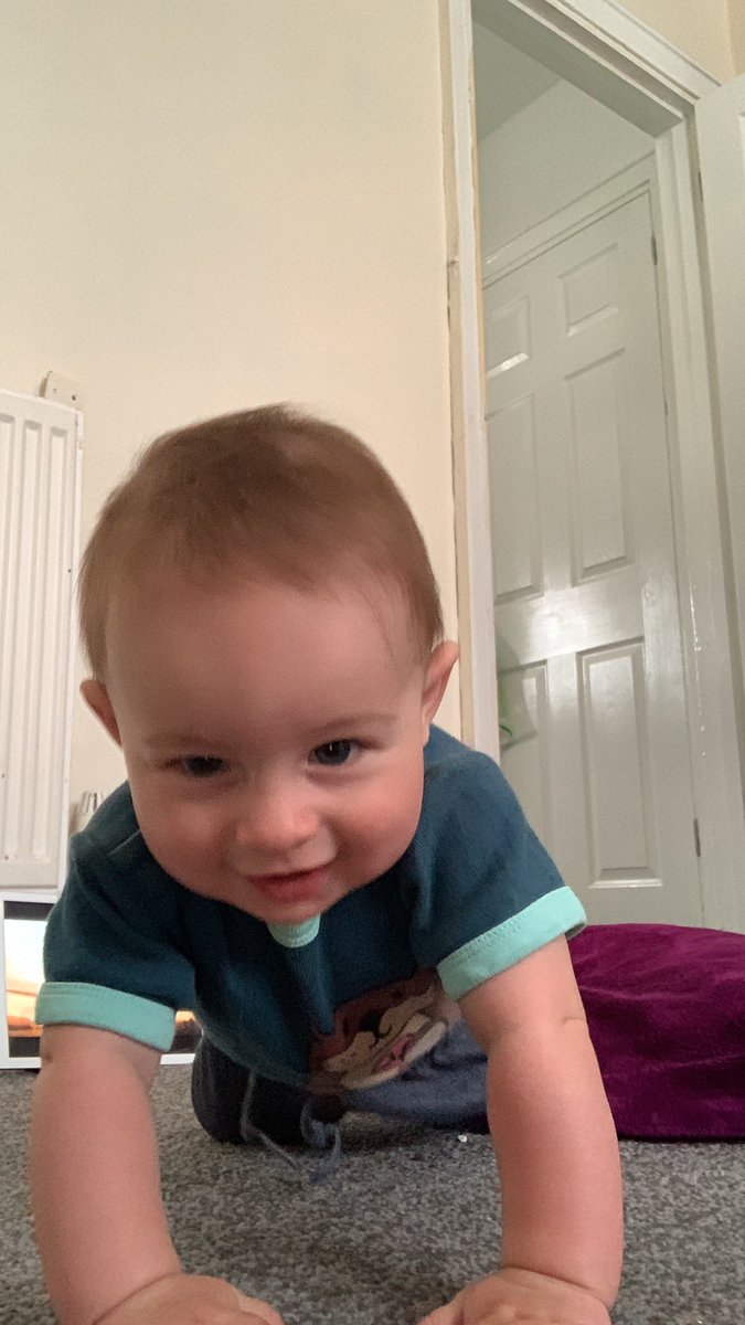 My 7 month old boy trying to crawl while taking a selfie