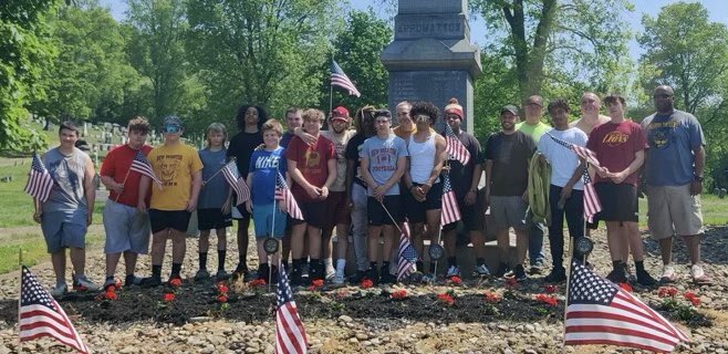 Lions Give Back Day! Today, members of the New Brighton Football Team helped the all volunteer staff at Grove Cemetery with some maintenance and placed American Flags at the sites of our Veterans. #NBProud