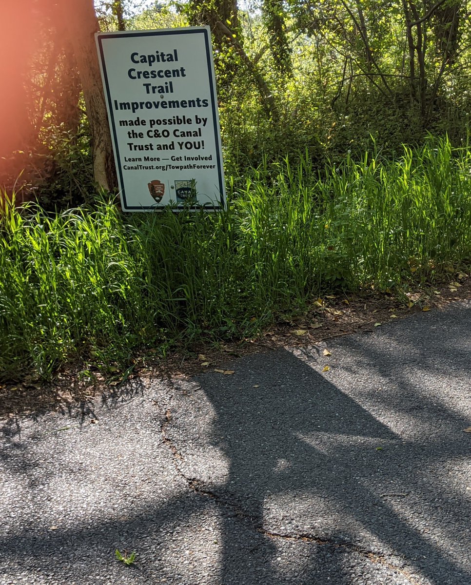 DouglasFBarnes's tweet photo. Every time I see this sign I wonder what the improvements are.  Notice tree root bulge just below sign. Capital crescent is over 25 years old and needs to be widened and repaved.  @CanalTrust 

Sorry for thumb! https://t.co/JXxmRg3Cxk