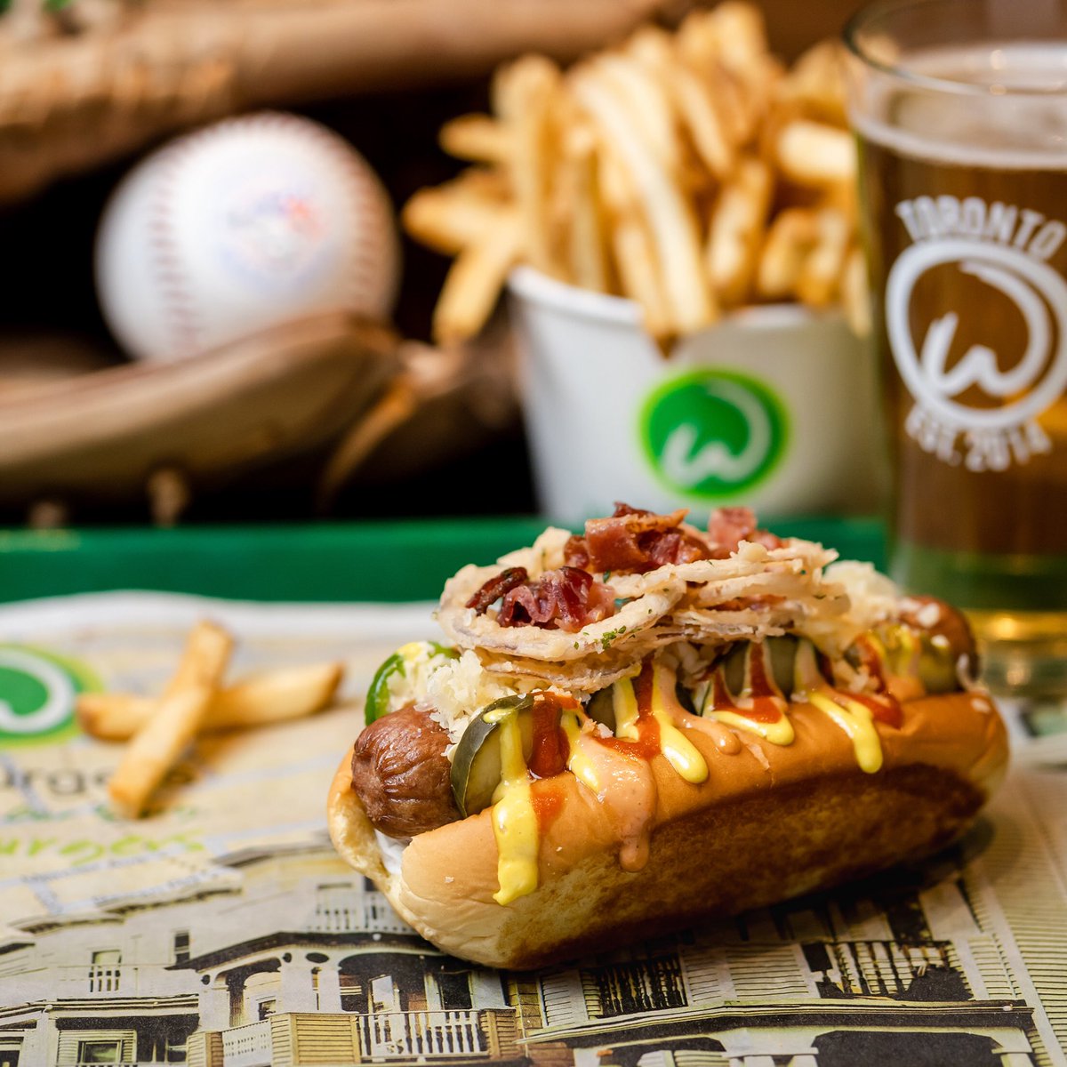 This Slugger never disappoints &amp; guarantees home runs with your tastebuds.

🌭 all natural beef hot dog • Crispy Thin Onion Rings • bacon • house made pickles • jalapenos • shredded white cheddar • Chef Paul’s signature housemade wahl sauce • house made mustard • sriracha