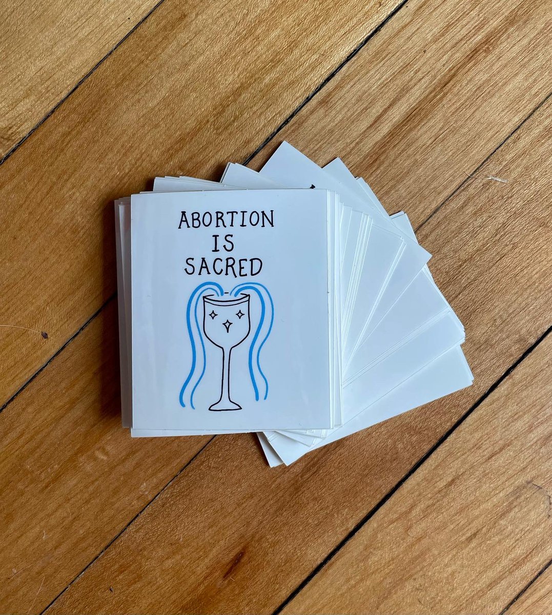 lesbiandotgov's tweet image. abortion is sacred stickers are here! available for $3 at the raven, soon at wonder fair, and you can also dm me if that’s easiest!