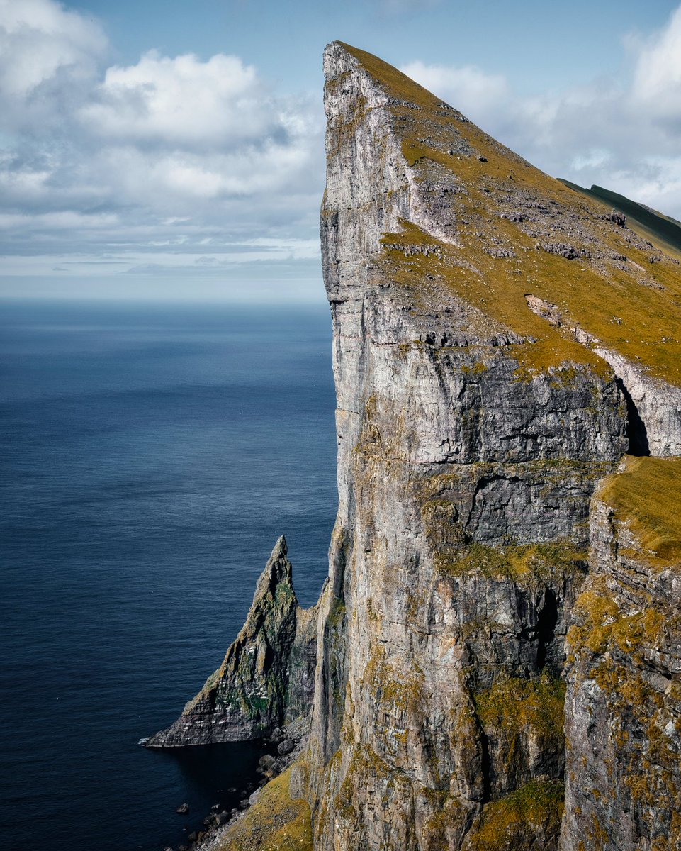 This cliff is 500+ meters in height straight down to the Atlantic Ocean. When you zoom in you should see some small white points (seagulls). If you manage to see the seagulls you can have an idea for the scale of this place. 

#landscapephotography #NFTs #photograghy #outdoor
