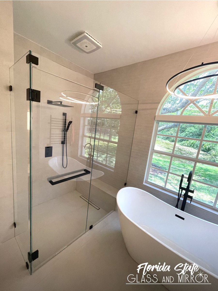 Ultramodern Frameless Shower Door design in Matte Black gives your bathroom a premium look. Call us now at 561-997-6990 to schedule a free consultation #framelessshowerdoor #blackhardware #shower #showers #showerenclosure #luxuryshower #glassexperts #floridastateglass