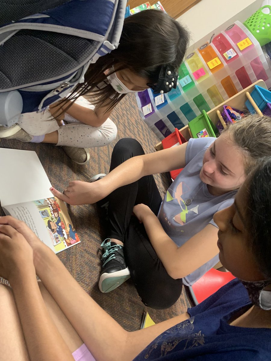ASE 4th Graders show off their Reading and Writing portfolios while 1st graders read their favorite books! We love to collaborate with our Dalmatian family! <a href="/ASE_Dalmatians/">Sullivan Elementary</a>