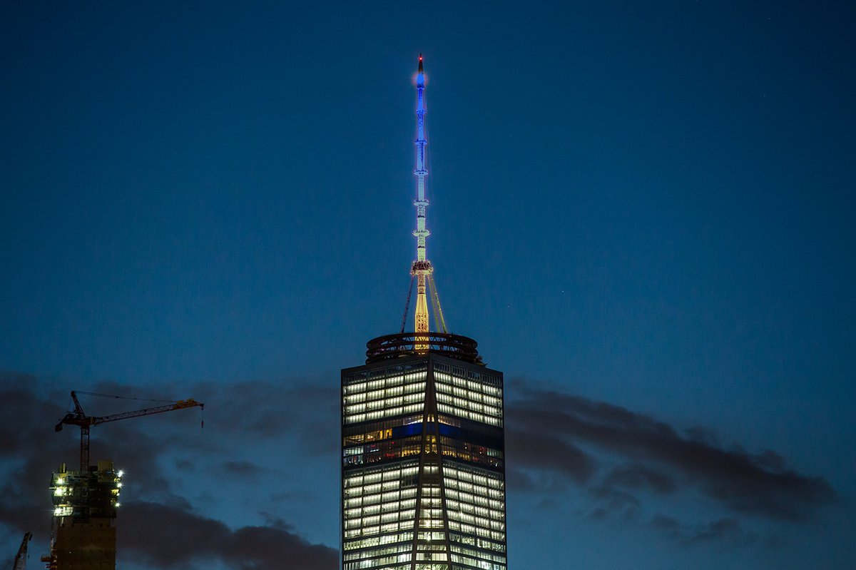 OneWTC's tweet photo. Tonight the spire and podium of #OneWTC are lit blue and yellow to celebrate 50 years of service from @CovenantHouse @CovenantHouseNY #RisingToTomorrow #CovenantHouse #spireworks @spireworks https://t.co/UBrnORdvSb