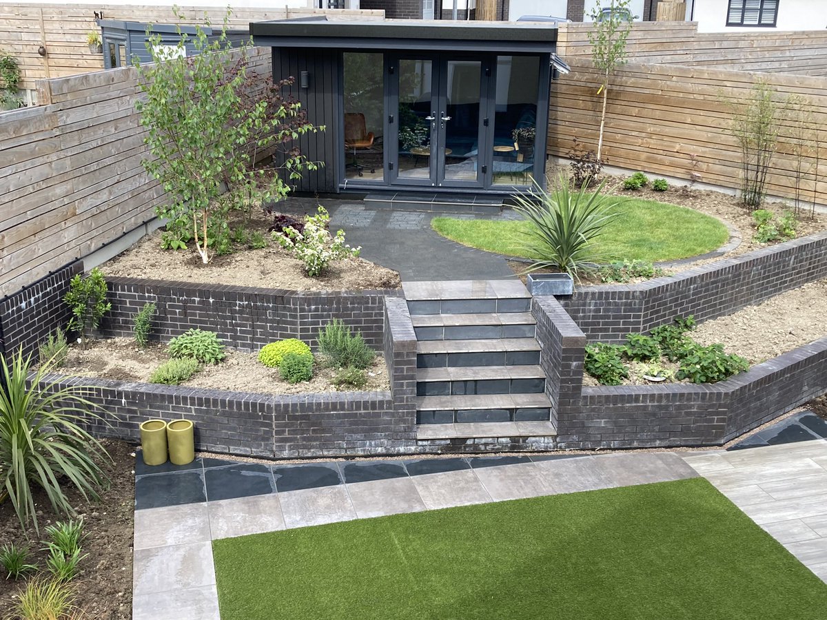 Completed installation in Conwy using #marshallsporcelain #artificalgrass project including pizza oven and outdoor office #marshallsregister #bestbyfar #landscape