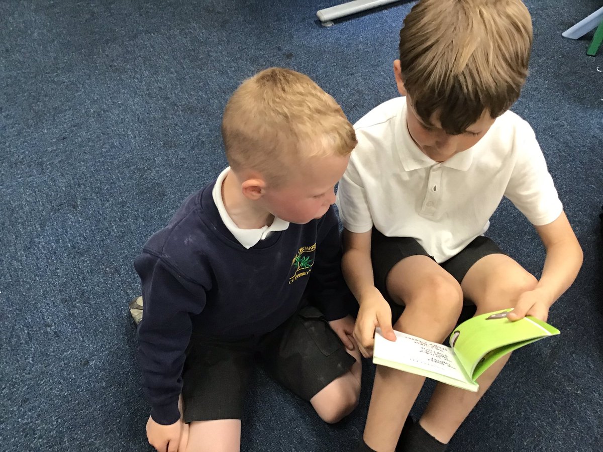Year 3 sharing their love of reading with Reception pupils.