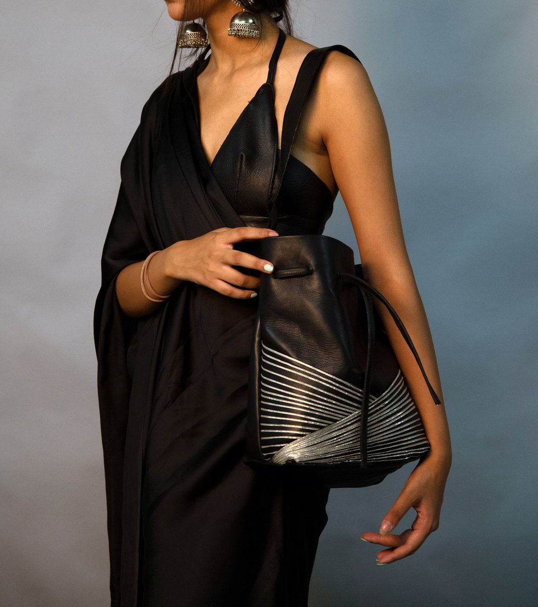 NiftKangra's tweet photo. Showcasing Venom - a black coloured bag made by student Armaan Dahiya (AD -4th Sem)
This bag is inspired by the Kalbelian tribe of Rajasthan and sports a mirage effect created by silver gota work.
#exams2022 #jury #designer #Accessories #bag #leather #kalbelian #gotawork https://t.co/ERnTKCBSQ8