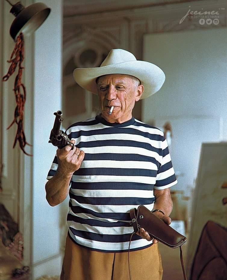 Spanish artist Pablo Picasso photographed smoking with a gun and holster in  hand. Photograph taken in Cannes, France in 1958. Credit: Jecinci  https://t.co/37rkKj96XJ⁠ #history #picasso #artist