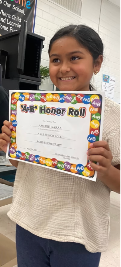 MichaelPNews's tweet photo. 10-year-old Amerie Jo Garza holds up a school certificate naming her to the honor roll at Robb Elementary School in Uvalde, Texas at 10 a.m. Tuesday. Hours later she would be killed at school. https://t.co/qMO3JSKIFu