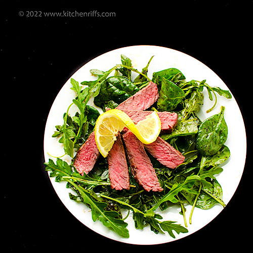 Seared Steak with Arugula and Spinach — fresh herbs, balsamic vinegar, and lemon juice liven up this simple summer supper: kitchenriffs.com/2022/05/seared…