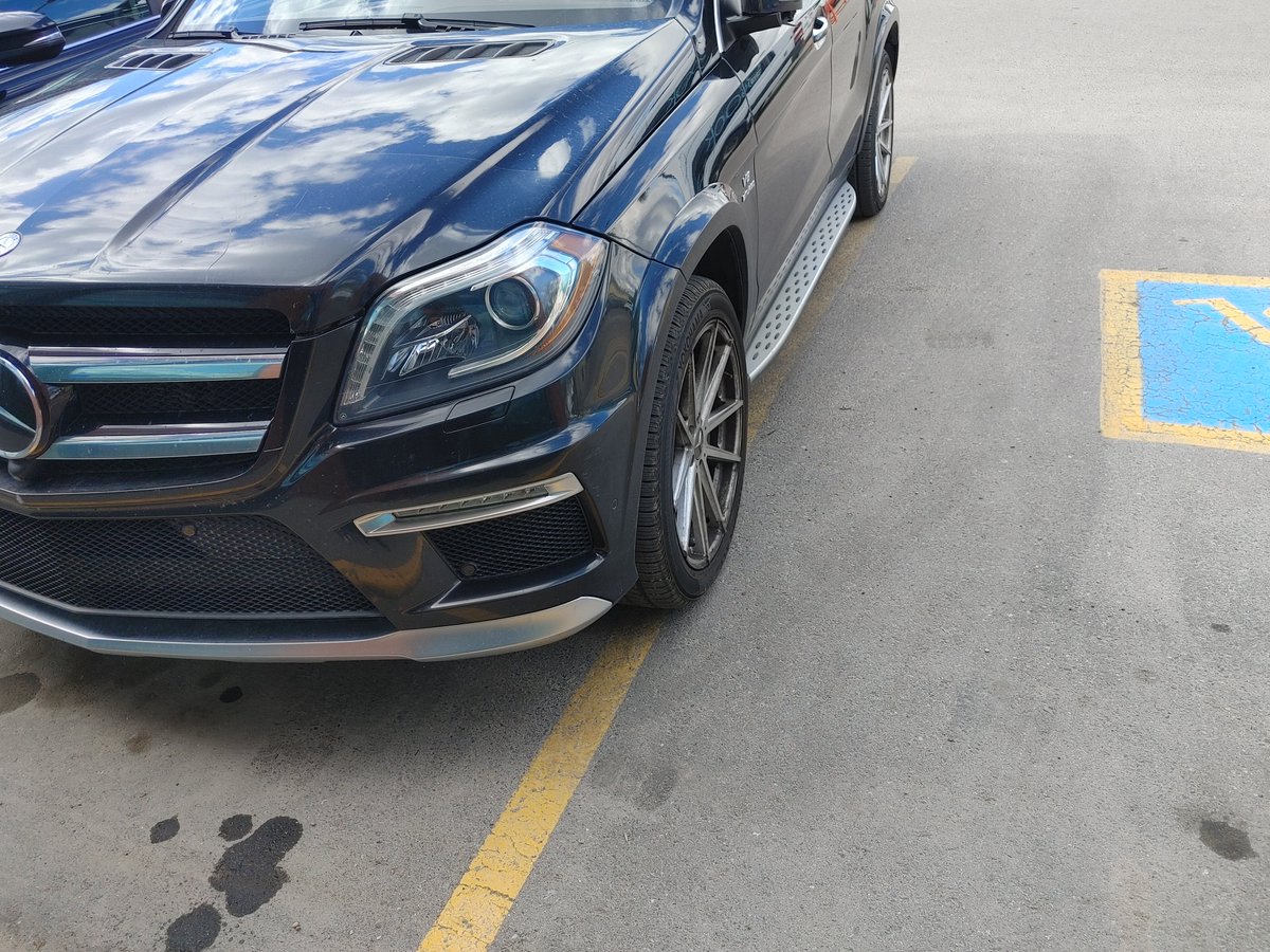 chikom's tweet photo. I'm a Mercedes, so I'm allowed to park over the line 
#entitlement #yyc https://t.co/kApnwSJ7Rt