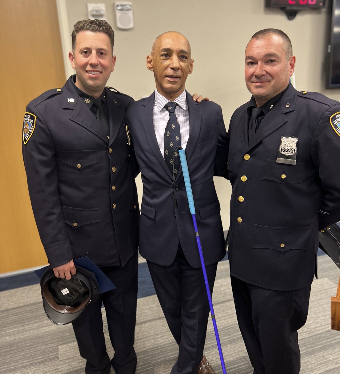 NYPDnews's tweet photo. After a blind man fell onto the tracks inside Brooklyn's Grant Avenue train station, Detective Greco and Officer Macaluso pulled him to safety just as a train was entering the station. Today, those officers reunited with him at a ceremony for the @MTA to show their gratitude. https://t.co/W5UICszuyW