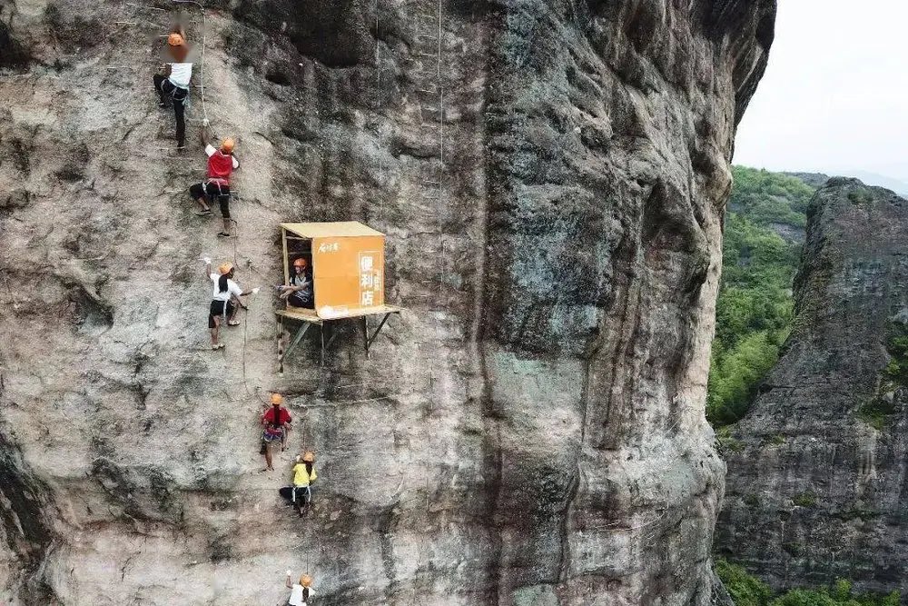 The world's 'most inconvenient' convenience store hangs off a cliff in China's Hunan province. 😳
