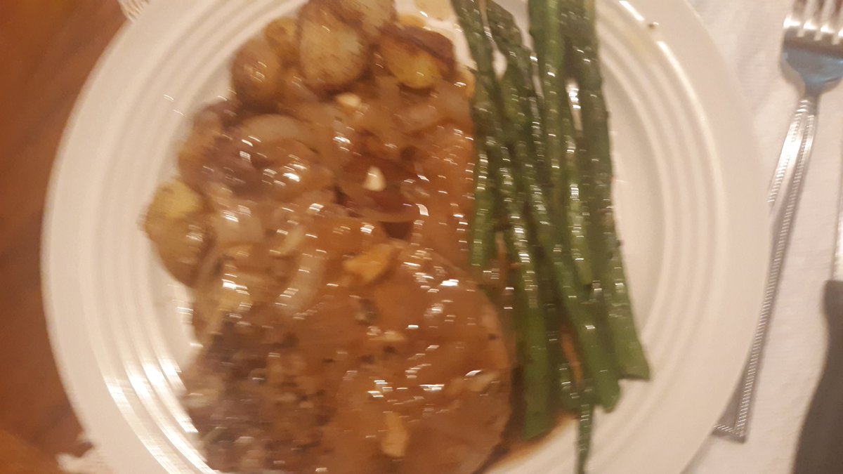 Pan roasted pork chop with brandy white wine, chicken sauce, over roasted potatoes and asparagus,