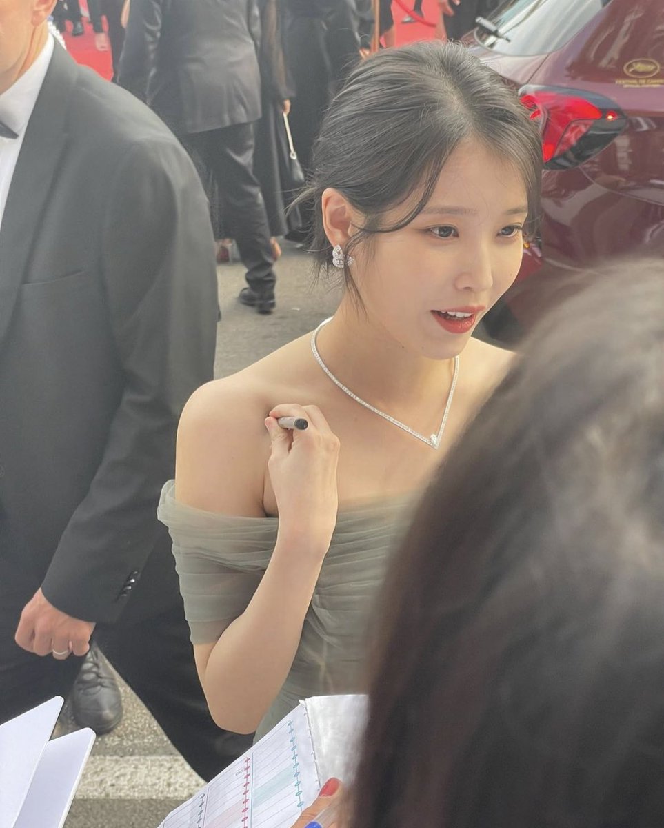 IU signing autographs for fans at #Cannes2022.
