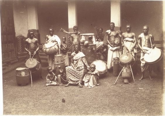 Some traditional drums of the Asantehene, photo taken in the 1870’s. The man sitting in front would be the caretaker. 1888-1895