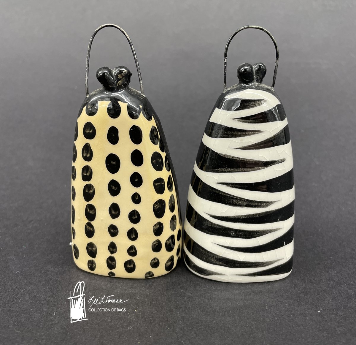 165/365: This pair of salt and pepper shakers have been styled to look like mini designer purses with their clasps and handles along the top. Made from ceramic and painted.