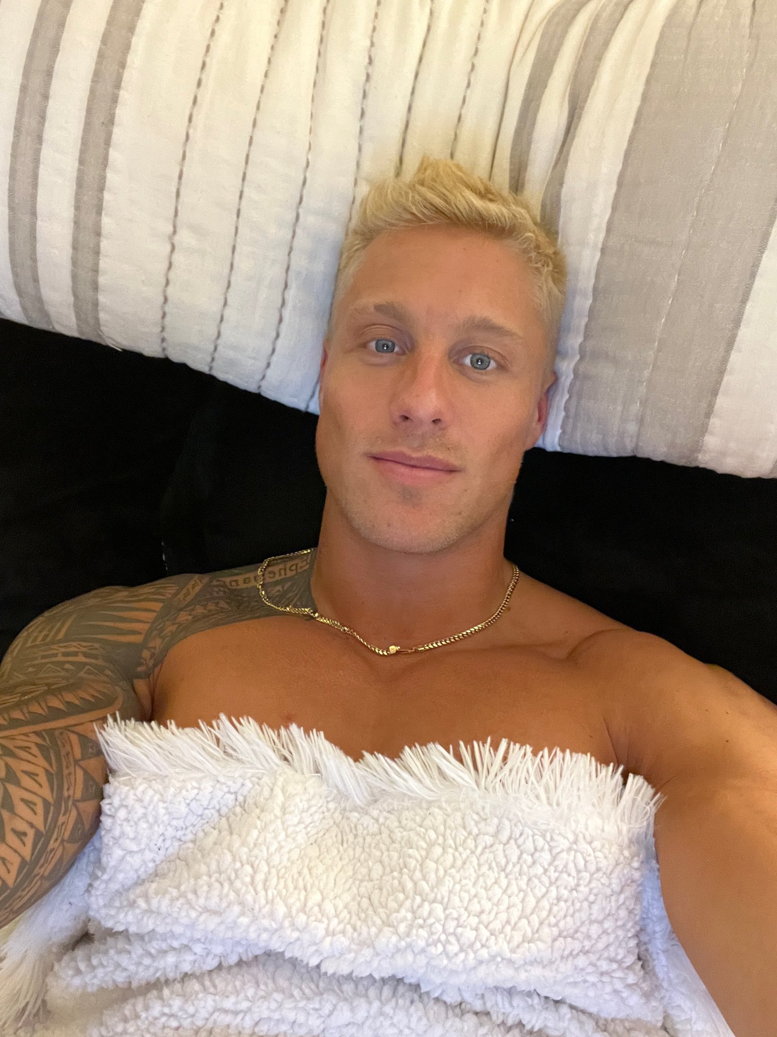 A man in a casual pose, with intriguing shadows