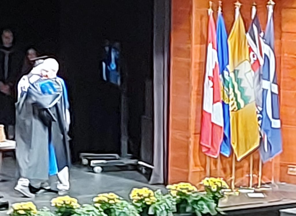 A moment 49 years in the making taking place at the University of Alberta's 2022 Convocation.  Andrew MacLean, B.A., B.Ed., Cert. being congratulated by Dr. Dan Syrotiuk Ph.D. Chief Marshall of the Convocation, Professor Emeritus, Coach and fellow Long Snapper.