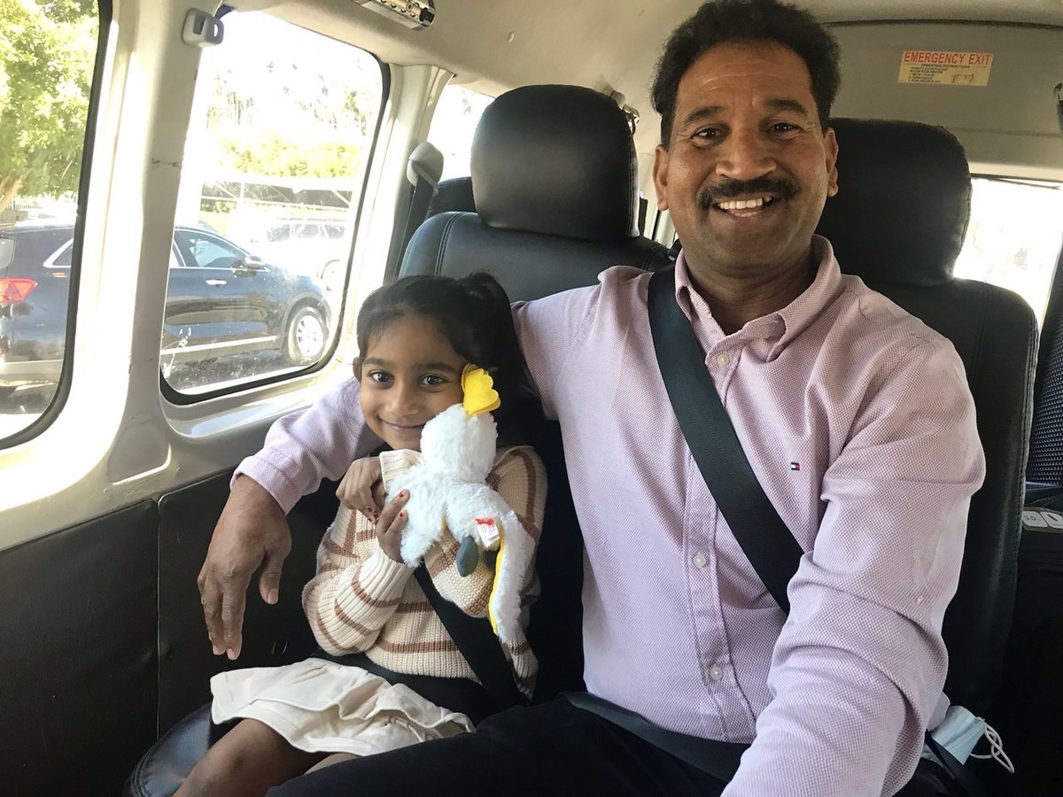 Smiling people in the back of a minivan