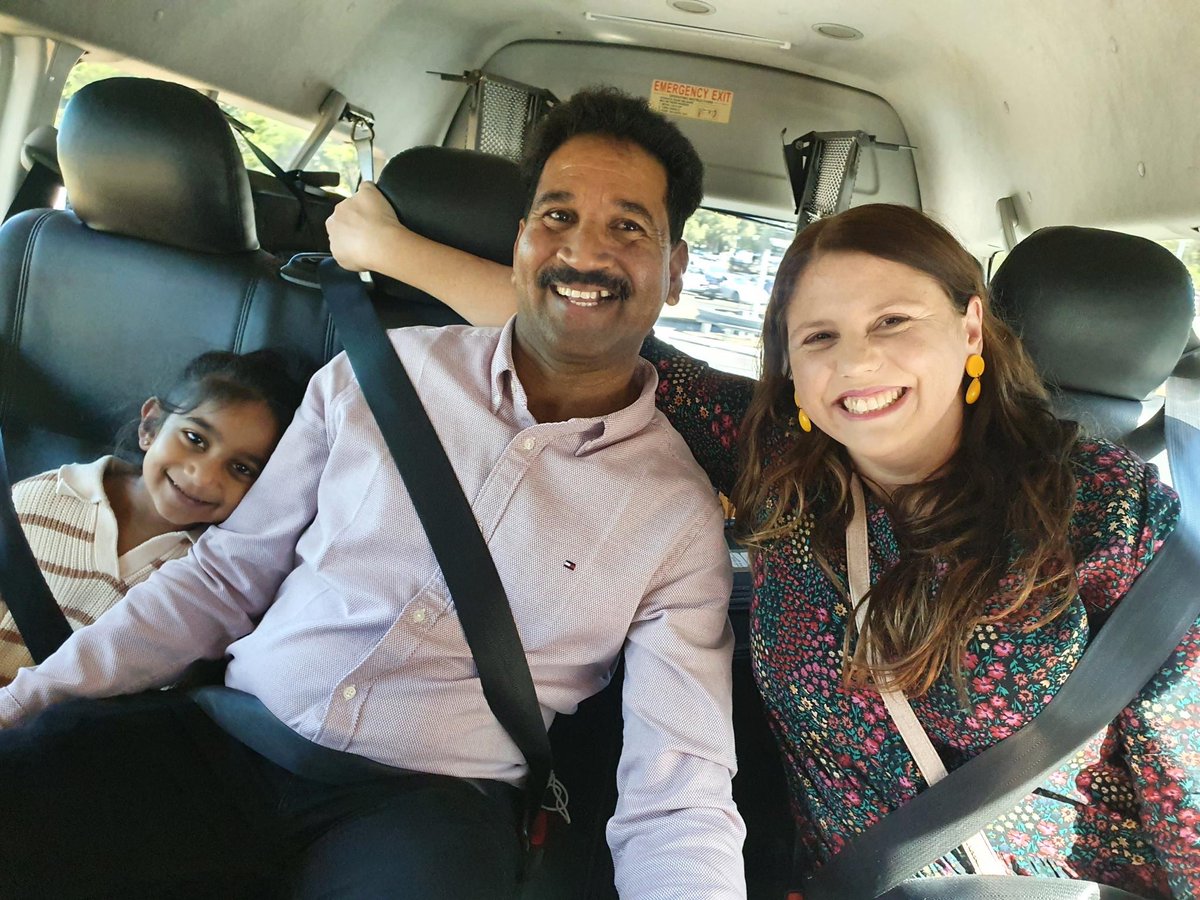 Smiling people in the back of a minivan