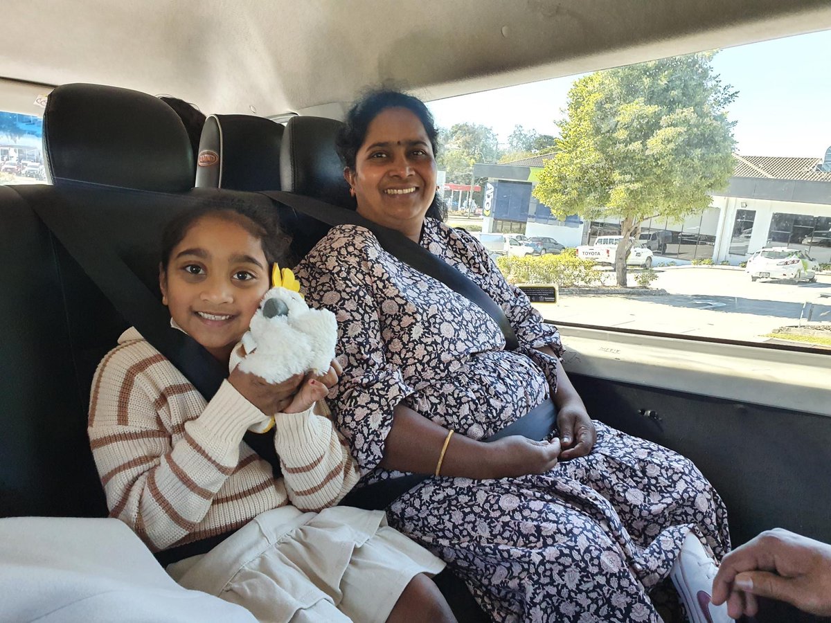 Smiling people in the back of a minivan