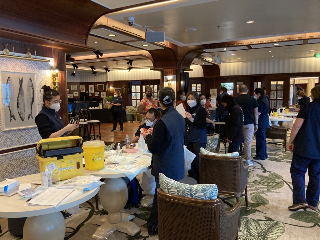 IntlSOSAU's tweet photo. All aboard! International SOS teamed up with @CarnivalAusNews to provide primary and booster COVID-19 and flu vaccines for maritime crew visa holders docked in Sydney #COVIDsafe https://t.co/hat48loU0o