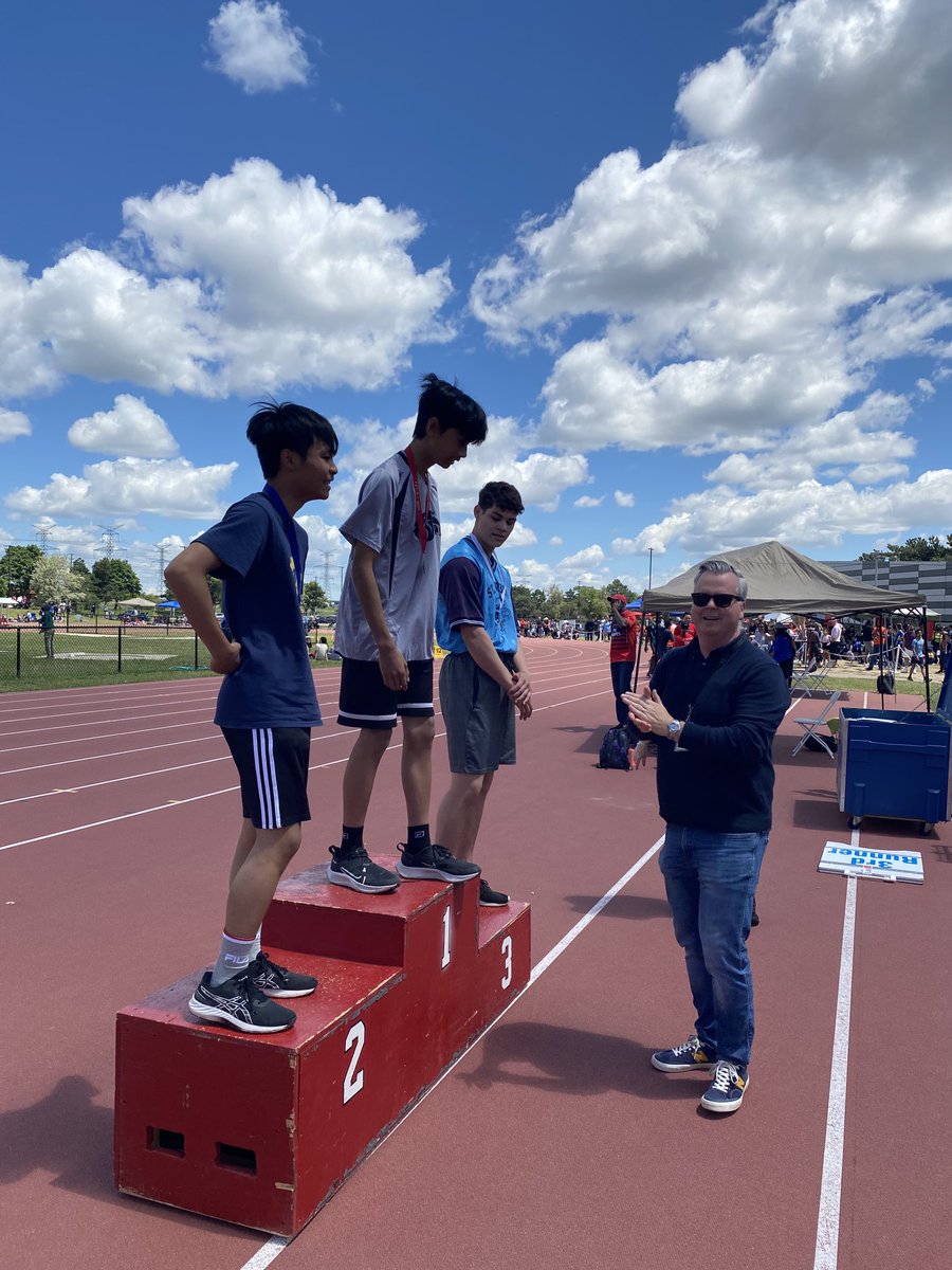 Director Brown presenting medals to top athletes at North Region Track!