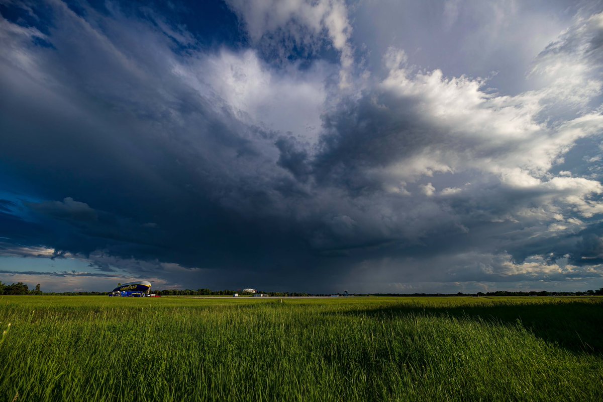 AndrewLeslie007's tweet photo. A small Thunderstorm cell passing in the distance as the Goodyear blimp gets tied down for the night at the Oshawa Airport. 

@weathernetwork @JWagstaffe @GoodyearBlimp https://t.co/YwQcRyhBBe