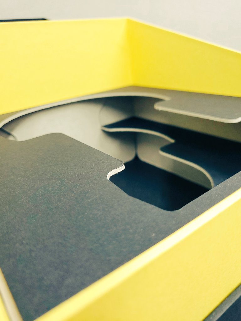 Presentation and security combined in an angled, rigid base and hinged lid. With die cut board insert to create 100% recyclability, once the box reaches the end of it's lifecycle.  <a href="/SensesPaper/">Senses Paper</a>