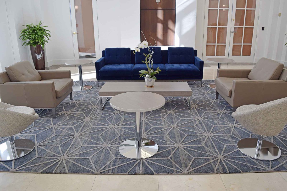 This area rug in the lobby of 2 Alahambra Plaza is a bespoke piece designed and hand-tufted specifically for this client! It's 100% New Zealand wool imparts the look and feel of luxury that the building exudes. #customflooring #woolcarpet