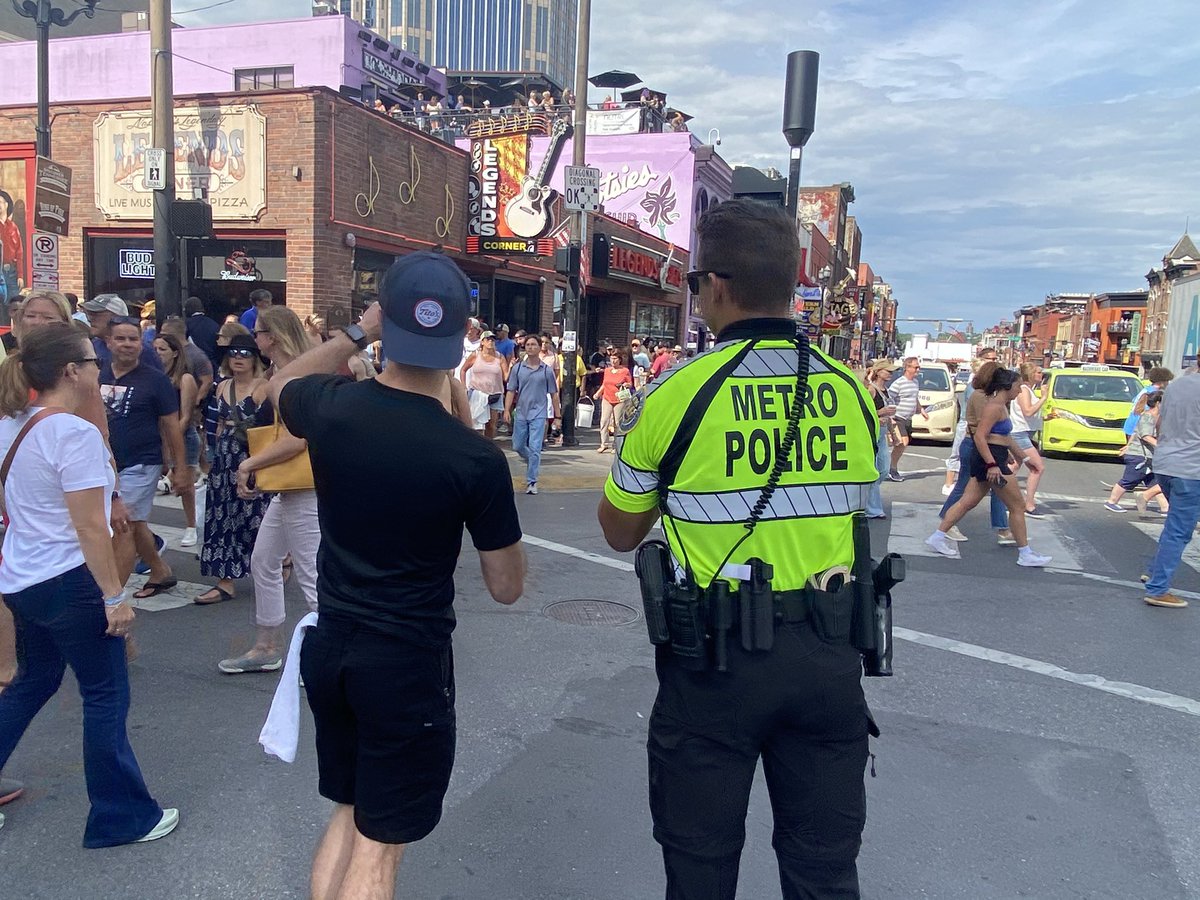 MNPDNashville's tweet photo. Officers are making sure the downtown footprint is safe for @CountryMusic Fest attendees on this warm Friday in Nashville. They’ll be working security and traffic posts throughout the weekend. Remember, if you see something, say something to a nearby officer. https://t.co/rXurI1ngqX