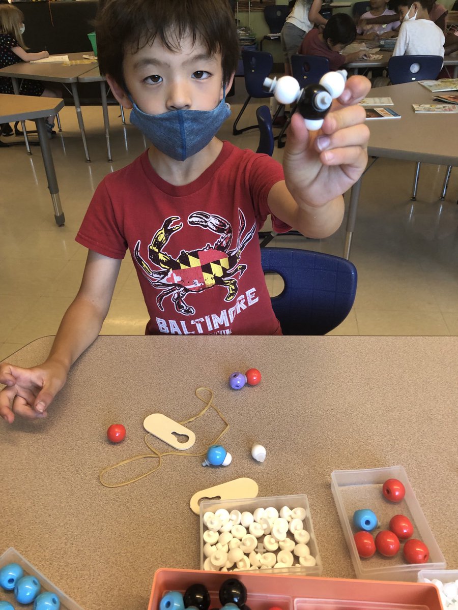 Look at my amazing discovery! Black and White molecules joined to form a . . .! I don’t know, but it was cool to play with the molecule making kit. My teacher is so cool to let us make molecules.