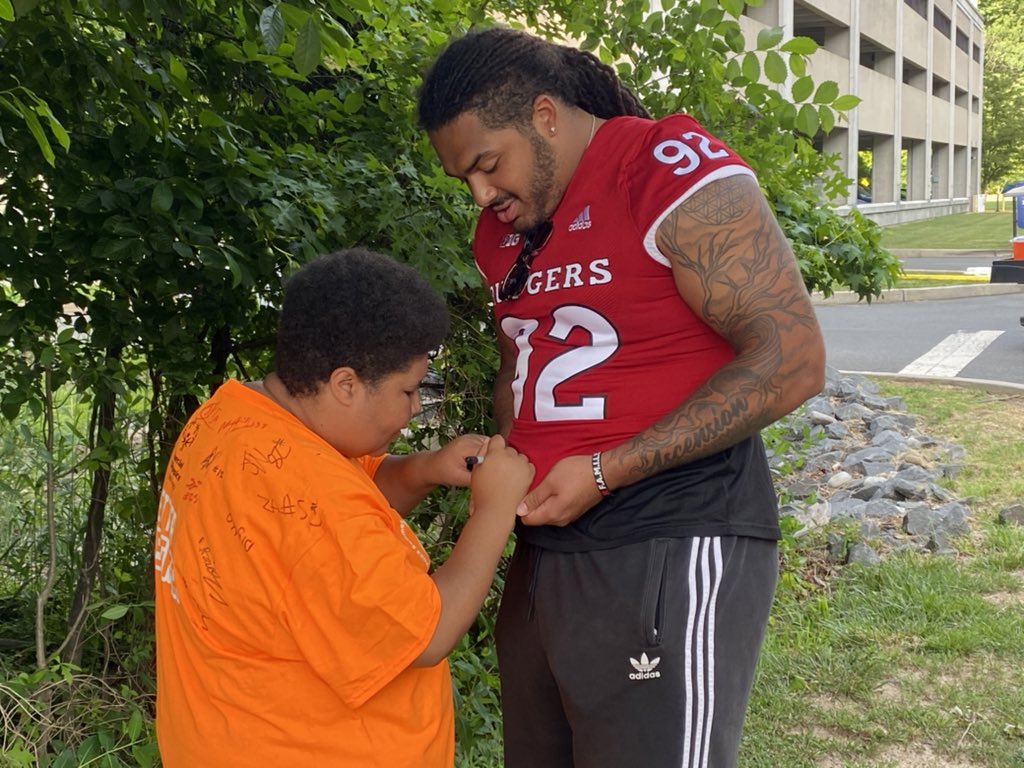 ChrisIseman's tweet photo. About 30 players represented Rutgers football tonight at the opening ceremony of the Special Olympics New Jersey’s Summer Games. One participant asked Mayan Ahanotu for his autograph and Ahanotu asked for one in return. https://t.co/aC0H5IcTkU