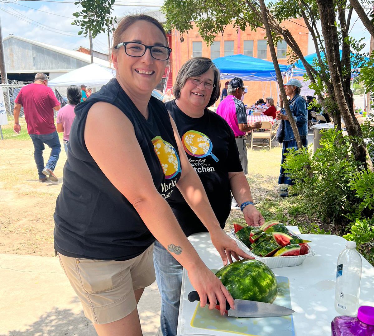 WCKitchen's tweet photo. From Uvalde, Texas where we have 5 restaurants serving today: Our awesome volunteer Josie cut slices of watermelon 🍉 for folks on this 100 degree day. David & Benya have been busy all morning handing out sandwiches. And the smoothies are a big hit with the kids! #ChefsForUvalde https://t.co/qgCnedlw4K