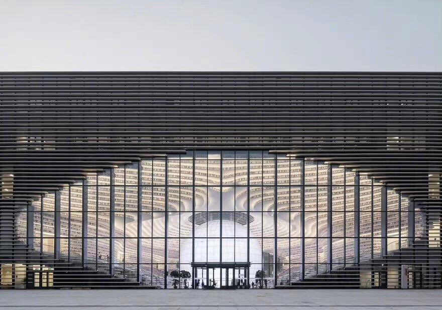 ExpatsHoliday's tweet photo. The Tianjin Binhai Library, Tianjin, China. I There's a giant globe in the center of the library. It has an auditorium hidden inside. The climbable shelving acts as a "book mountain." #chinatravel #library #China https://t.co/limdxorEW7