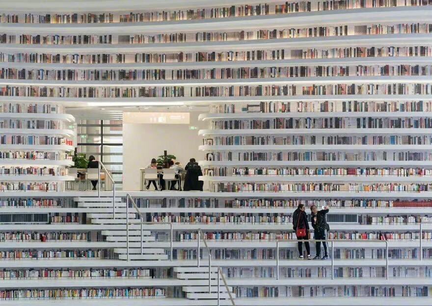 ExpatsHoliday's tweet photo. The Tianjin Binhai Library, Tianjin, China. I There's a giant globe in the center of the library. It has an auditorium hidden inside. The climbable shelving acts as a "book mountain." #chinatravel #library #China https://t.co/limdxorEW7