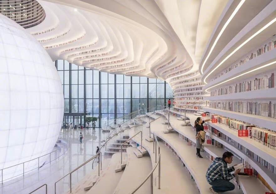 ExpatsHoliday's tweet photo. The Tianjin Binhai Library, Tianjin, China. I There's a giant globe in the center of the library. It has an auditorium hidden inside. The climbable shelving acts as a "book mountain." #chinatravel #library #China https://t.co/limdxorEW7
