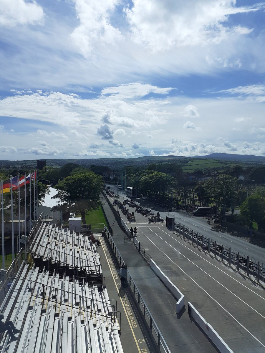 Oscar17IOM's tweet photo. Grandstand and Glencrutchery Road looking fantastic in the sunshine. This is my view from Race Control tonight. Hoping the practice gets off ok.  The island is getting busier! #iomtt2022 https://t.co/O5cya1NrMq