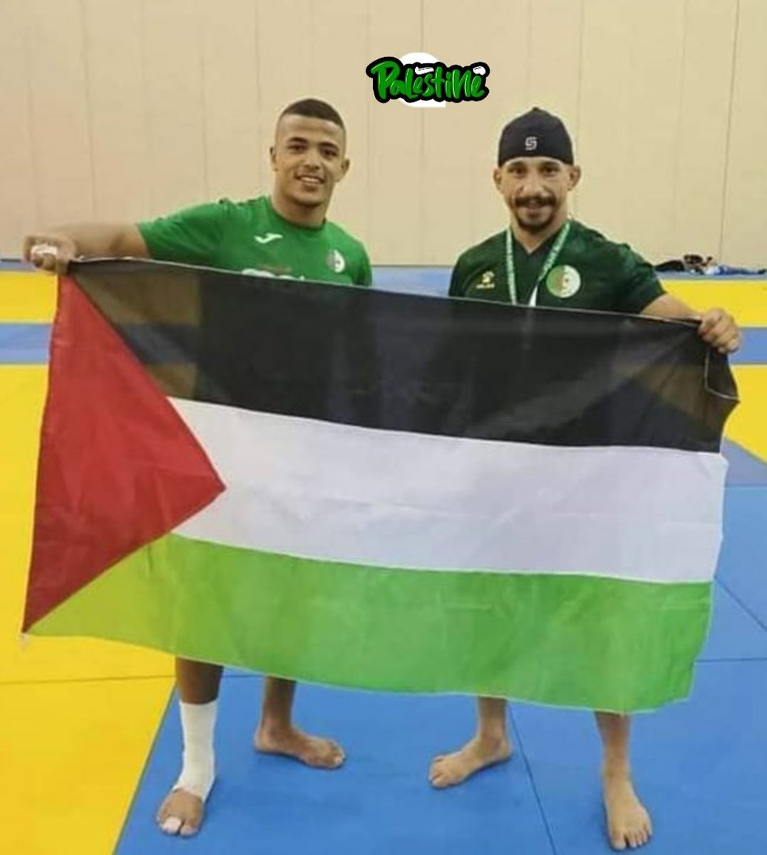 #photo|  Algerian players Houd Zerdani and Idriss Messaoud raise the flag of #Palestine during the 2022 African Judo Championship