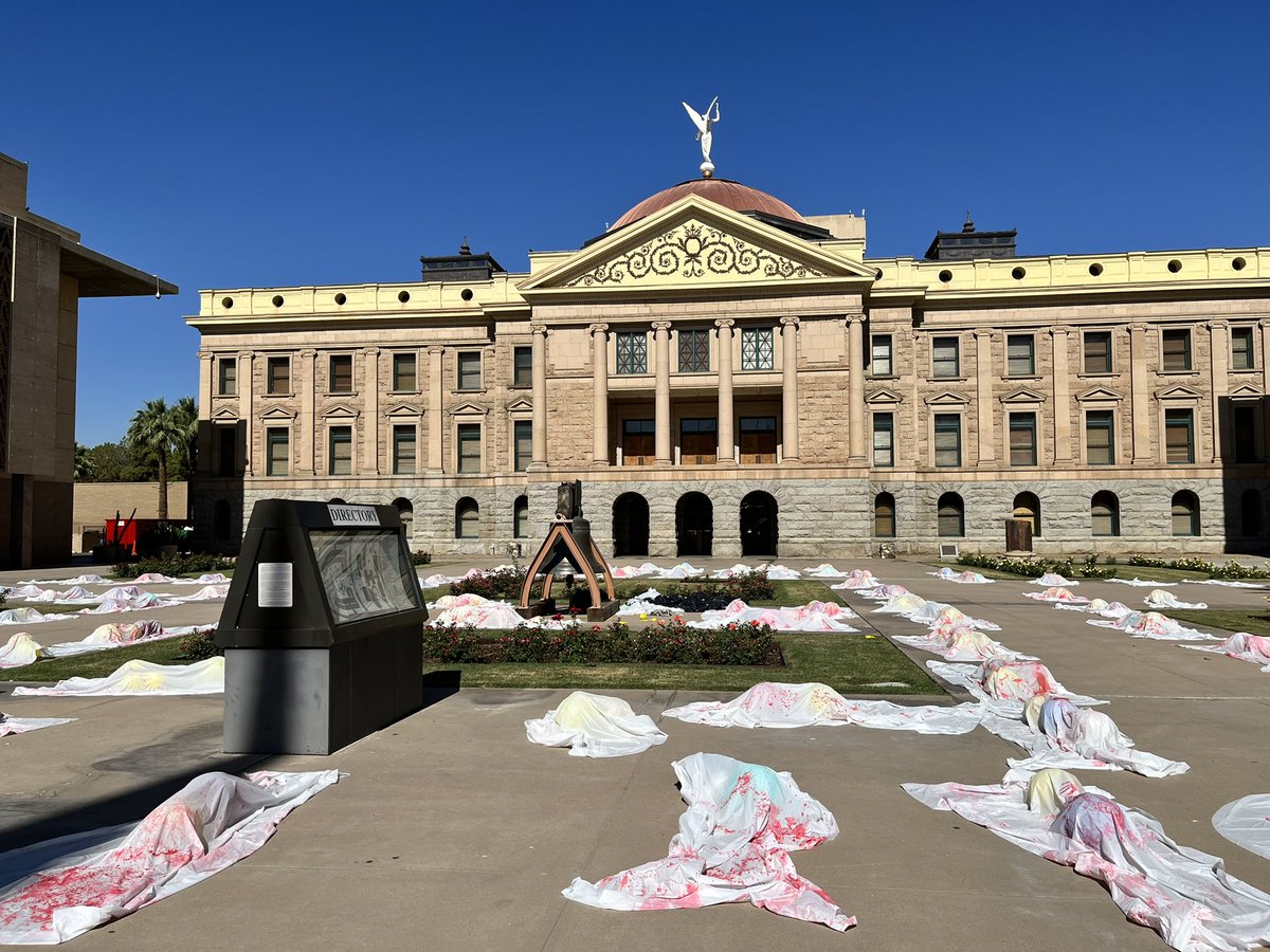 azmfol's tweet photo. Today, Marchers at the Arizona State Capitol acted to urge our representatives for change. These body bags embody the innocent student, teachers, and citizens who were shot and killed in mass shootings. This should not be happening anymore. Join us on June 11th for more action. https://t.co/pDE5ZGRoik