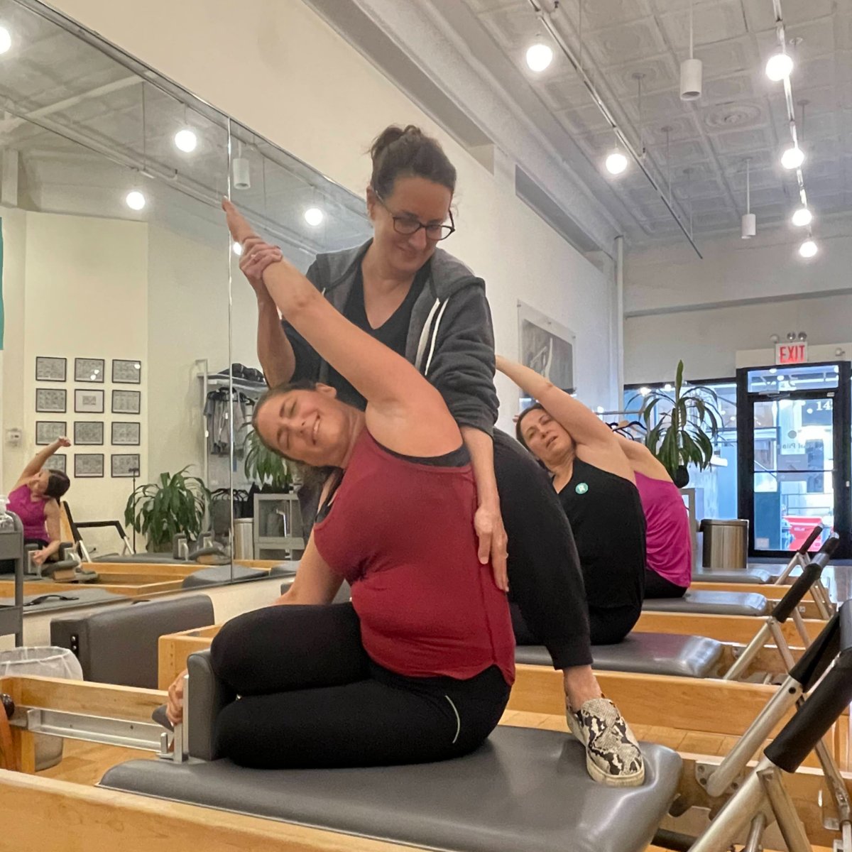 RealPilates's tweet photo. I'm not smiling - you're smiling! Ok - ok. We're *both* smiling. That's what Pilates does. Share a Pilates smile with your favorite duet partner. Duet bookings are available in all locations! #Pilatespartners #PilatesDuos #PilatesDuets #PilatesPairs #BookNow #RealPilates https://t.co/KwOrnpx0VP