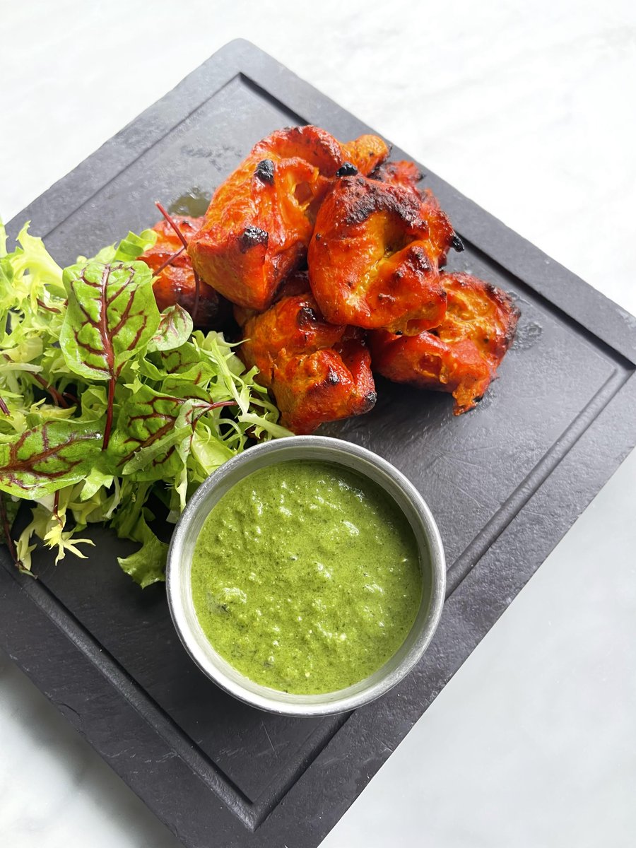 Chicken Tikka - small pieces of boneless chicken coated in yogurt and house spices and baked on skewers in one of our tandoor ovens - is a traditional Indian dish that serves as a starter at Karma Modern Indian and can be found on the "Shared Moments" section of the menu.