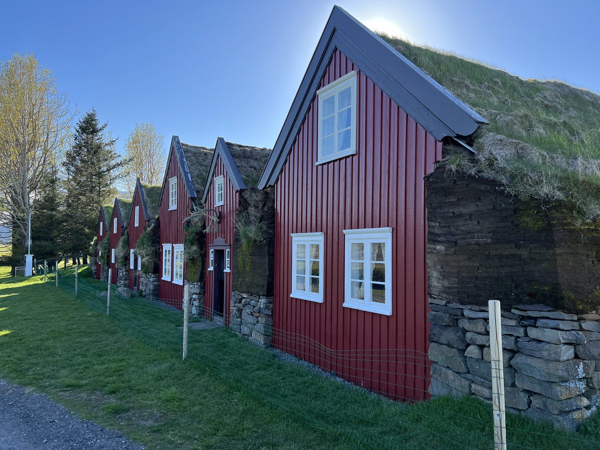 lbleamas's tweet photo. Day 9, part 2: longest day of driving had us continuing east and north through the fjords and the mountain (relatively new tunnel cut 50 km off the normal route). Then a stop at historic turf houses (red) from 1770, before our modern turf hotel (blue). @Trinity_U #goTUiceland https://t.co/Iv1WskxXUf
